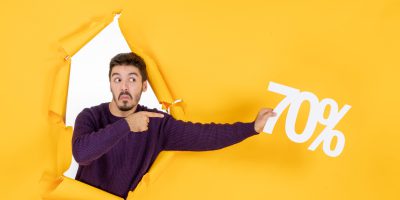front view young male holding writing on yellow background color shopping holidays gift xmas photo